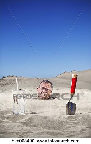Caucasian man buried in sand next to glass of water and trowel View Large Photo Image Stock Image - Caucasian man buried in sand next to glass of water and trowel. Fotosearch