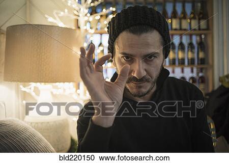 Stock Image - Caucasian man demonstrating size with fingers. Fotosearch