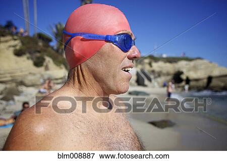 Caucasian man in swim cap and goggles on beach View Large Photo Image Stock Photo - Caucasian man in swim cap and goggles on beach. Fotosearch