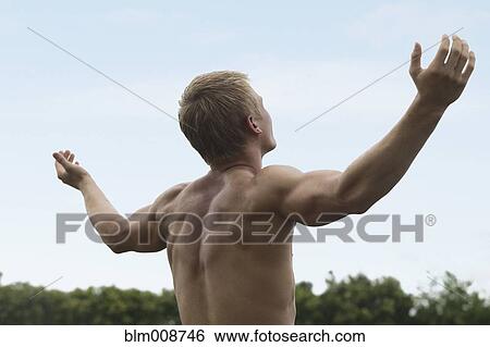 Caucasian man outdoors with arms outstretched View Large Photo Image Stock Photograph - Caucasian man outdoors with arms outstretched. Fotosearch