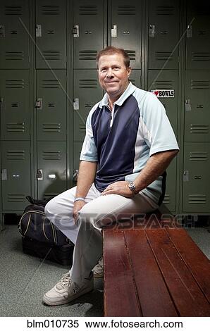 Caucasian man sitting on bench in locker room View Large Photo Image Stock Photography - Caucasian man sitting on bench in locker room. Fotosearch
