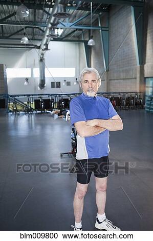 Caucasian man standing in health club View Large Photo Image Stock Image - Caucasian man standing in health club. Fotosearch