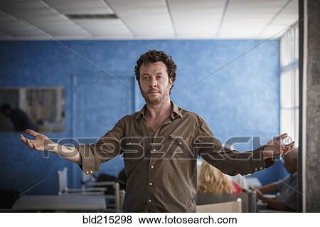 Caucasian man standing with arms outstretched in living room View Large Photo Image Stock Photo - Caucasian man standing with arms outstretched in living room. Fotosearch