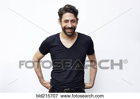 Stock Photo - Caucasian man standing with hands on hips. Fotosearch