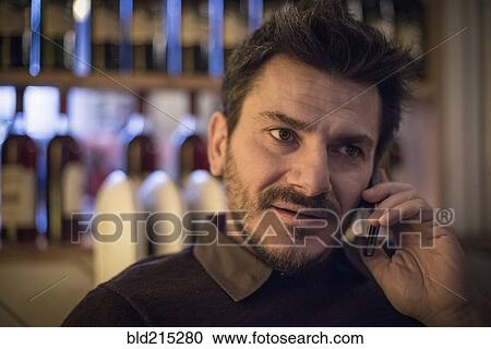 Stock Image - Caucasian man talking on cell phone. Fotosearch