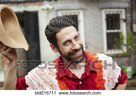 Caucasian man tipping straw hat in backyard View Large Photo Image Stock Image - Caucasian man tipping straw hat in backyard. Fotosearch