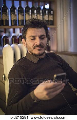 Caucasian man using cell phone View Large Photo Image Stock Image - Caucasian man using cell phone. Fotosearch