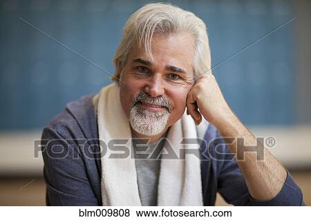 Stock Photo - Caucasian man with towel around his neck. Fotosearch