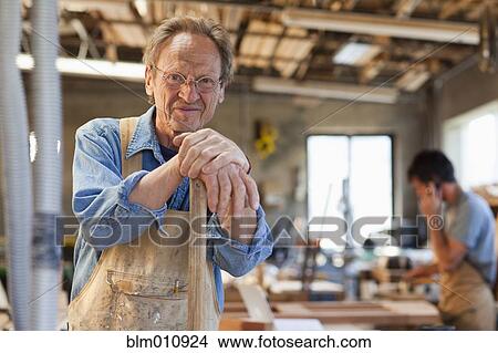 Picture - Caucasian men working in carpentry workshop. Fotosearch