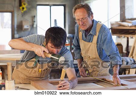 Caucasian men working in carpentry workshop View Large Photo Image Stock Image - Caucasian men working in carpentry workshop. Fotosearch
