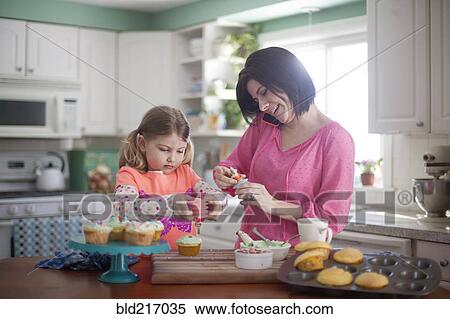 Caucasian mother and daughter baking in kitchen View Large Photo Image Stock Photography - Caucasian mother and daughter baking in kitchen. Fotosearch