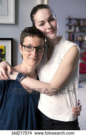 Caucasian mother and daughter hugging View Large Photo Image Picture - Caucasian mother and daughter hugging. Fotosearch