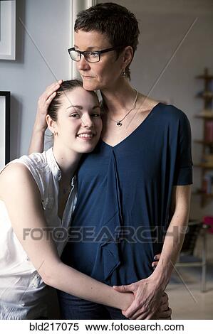 Caucasian mother and daughter hugging View Large Photo Image Stock Photography - Caucasian mother and daughter hugging. Fotosearch