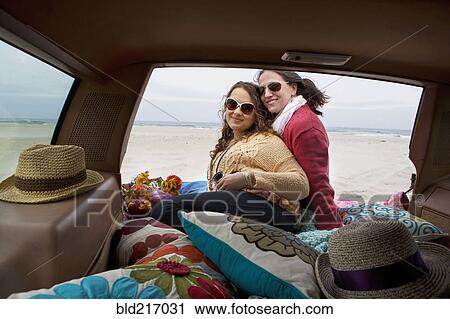 Stock Image - Caucasian mother and daughter posing in car. Fotosearch