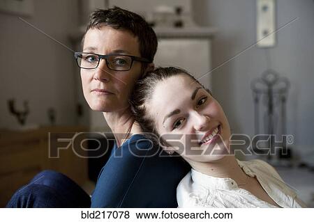 Caucasian mother and daughter sitting back to back View Large Photo Image Stock Photo - Caucasian mother and daughter sitting back to back. Fotosearch
