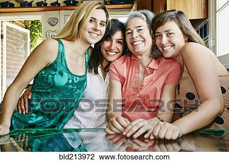 Caucasian mother and daughters hugging in kitchen View Large Photo Image Stock Image - Caucasian mother and daughters hugging in kitchen. Fotosearch