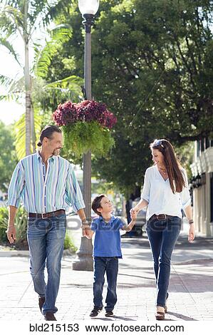Caucasian mother and father walking with son on sidewalk View Large Photo Image Stock Image - Caucasian mother and father walking with son on sidewalk. Fotosearch