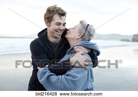 Caucasian mother and son hugging on beach View Large Photo Image Stock Photo - Caucasian mother and son hugging on beach. Fotosearch