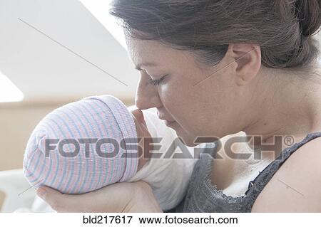 Caucasian mother rubbing noses with newborn daughter View Large Photo Image Stock Photo - Caucasian mother rubbing noses with newborn daughter. Fotosearch