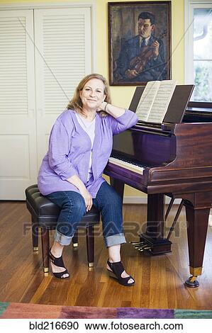 Stock Image - Caucasian musician sitting at piano. Fotosearch