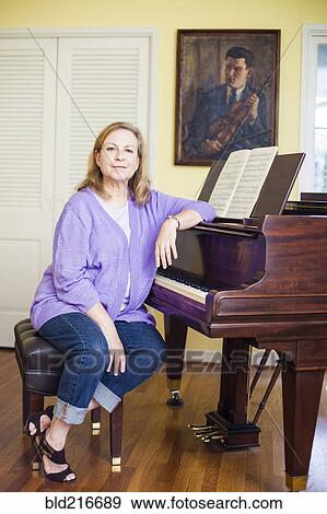 Stock Photo - Caucasian musician sitting at piano. Fotosearch