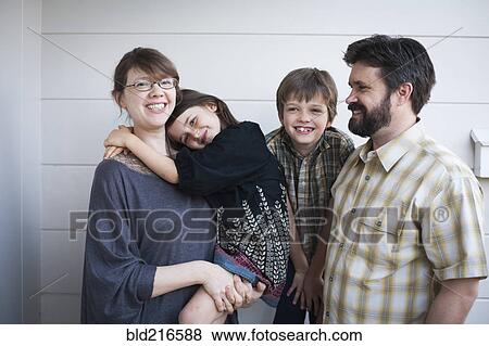 Stock Photo - Caucasian parents and children smiling outdoors. Fotosearch