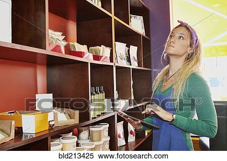 Caucasian server using tablet computer in cafe View Large Photo Image Stock Photography - Caucasian server using tablet computer in cafe. Fotosearch