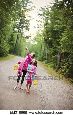 Stock Photography - Caucasian sisters admiring forest view. Fotosearch
