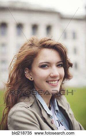 Stock Photography - Caucasian student smiling on college campus. Fotosearch