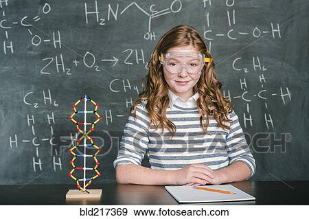 Stock Photo - Caucasian student wearing safety goggles in science class. Fotosearch
