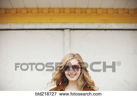 Stock Photo - Caucasian teenage girl smiling in sunglasses. Fotosearch