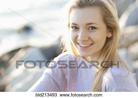 Stock Image - Caucasian teenage girl smiling outdoors. Fotosearch