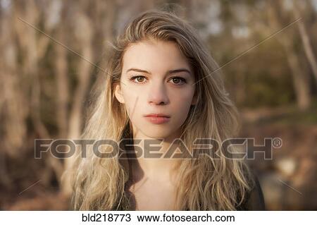 Caucasian teenage girl standing in park View Large Photo Image Stock Image - Caucasian teenage girl standing in park. Fotosearch