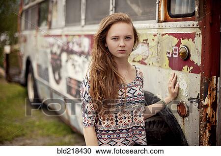 Caucasian teenage girl standing near dilapidated bus View Large Photo Image Stock Image - Caucasian teenage girl standing near dilapidated bus. Fotosearch