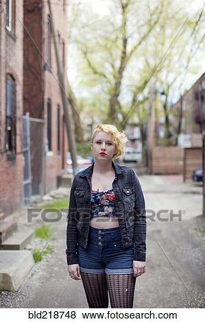 Caucasian teenage girl standing on city sidewalk View Large Photo Image Stock Photo - Caucasian teenage girl standing on city sidewalk. Fotosearch
