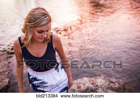 Caucasian teenage girl standing on riverbank View Large Photo Image Picture - Caucasian teenage girl standing on riverbank. Fotosearch