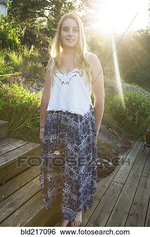 Caucasian teenage girl standing on wooden walkway View Large Photo Image Stock Photograph - Caucasian teenage girl standing on wooden walkway. Fotosearch