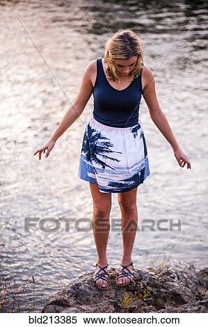 Caucasian teenage girl standing on rocky riverbank View Large Photo Image Stock Photography - Caucasian teenage girl standing on rocky riverbank. Fotosearch