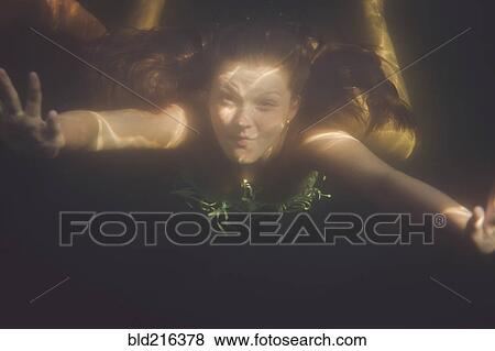 Caucasian teenage girl swimming underwater in lake View Large Photo Image Stock Photo - Caucasian teenage girl swimming underwater in lake. Fotosearch