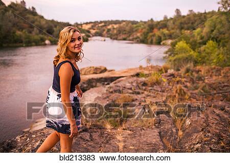 Caucasian teenage girl walking on riverbank View Large Photo Image Stock Image - Caucasian teenage girl walking on riverbank. Fotosearch