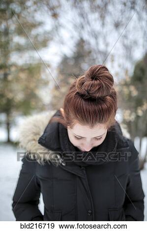 Stock Photo - Caucasian teenage girl wearing parka outdoors. Fotosearch