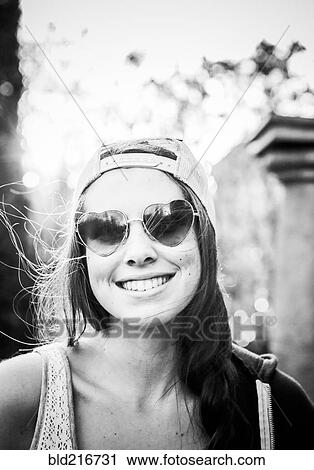 Caucasian teenage girl wearing heart-shaped sunglasses View Large Photo Image Stock Image - Caucasian teenage girl wearing heart-shaped sunglasses. Fotosearch