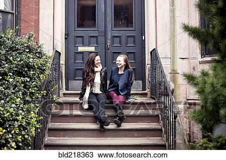 Caucasian teenage girls laughing on front stoop View Large Photo Image Stock Image - Caucasian teenage girls laughing on front stoop. Fotosearch