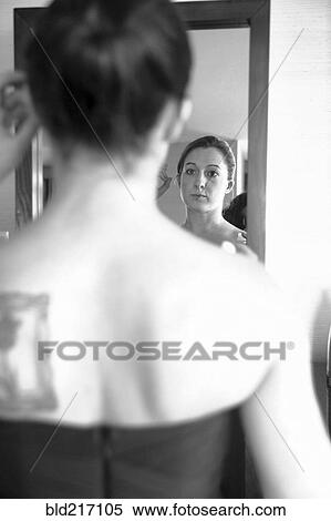 Caucasian woman admiring herself in mirror View Large Photo Image Stock Photography - Caucasian woman admiring herself in mirror. Fotosearch
