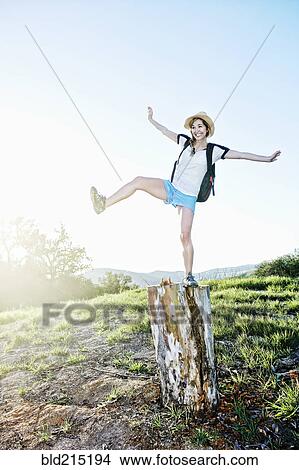 Caucasian woman balancing on dilapidated stump View Large Photo Image Picture - Caucasian woman balancing on dilapidated stump. Fotosearch