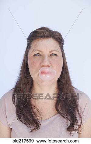 Caucasian woman blowing bubble with gum View Large Photo Image Stock Photo - Caucasian woman blowing bubble with gum. Fotosearch