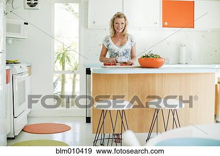 Caucasian woman cooking in kitchen View Large Photo Image Stock Photo - Caucasian woman cooking in kitchen. Fotosearch