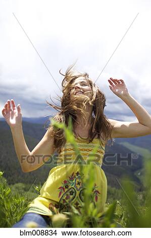 Picture - Caucasian woman dancing outdoors. Fotosearch