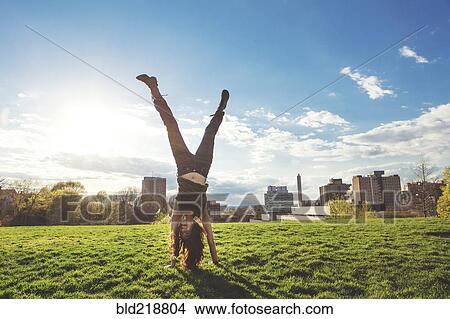 Caucasian woman doing handstand in urban park View Large Photo Image Picture - Caucasian woman doing handstand in urban park. Fotosearch