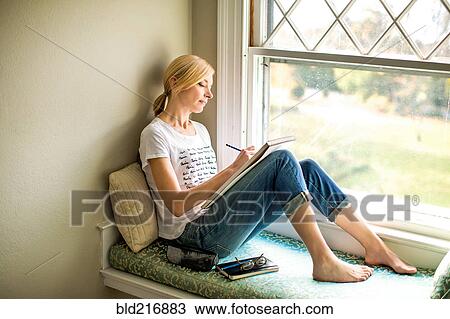 Caucasian woman drawing in windowsill View Large Photo Image Stock Image - Caucasian woman drawing in windowsill. Fotosearch